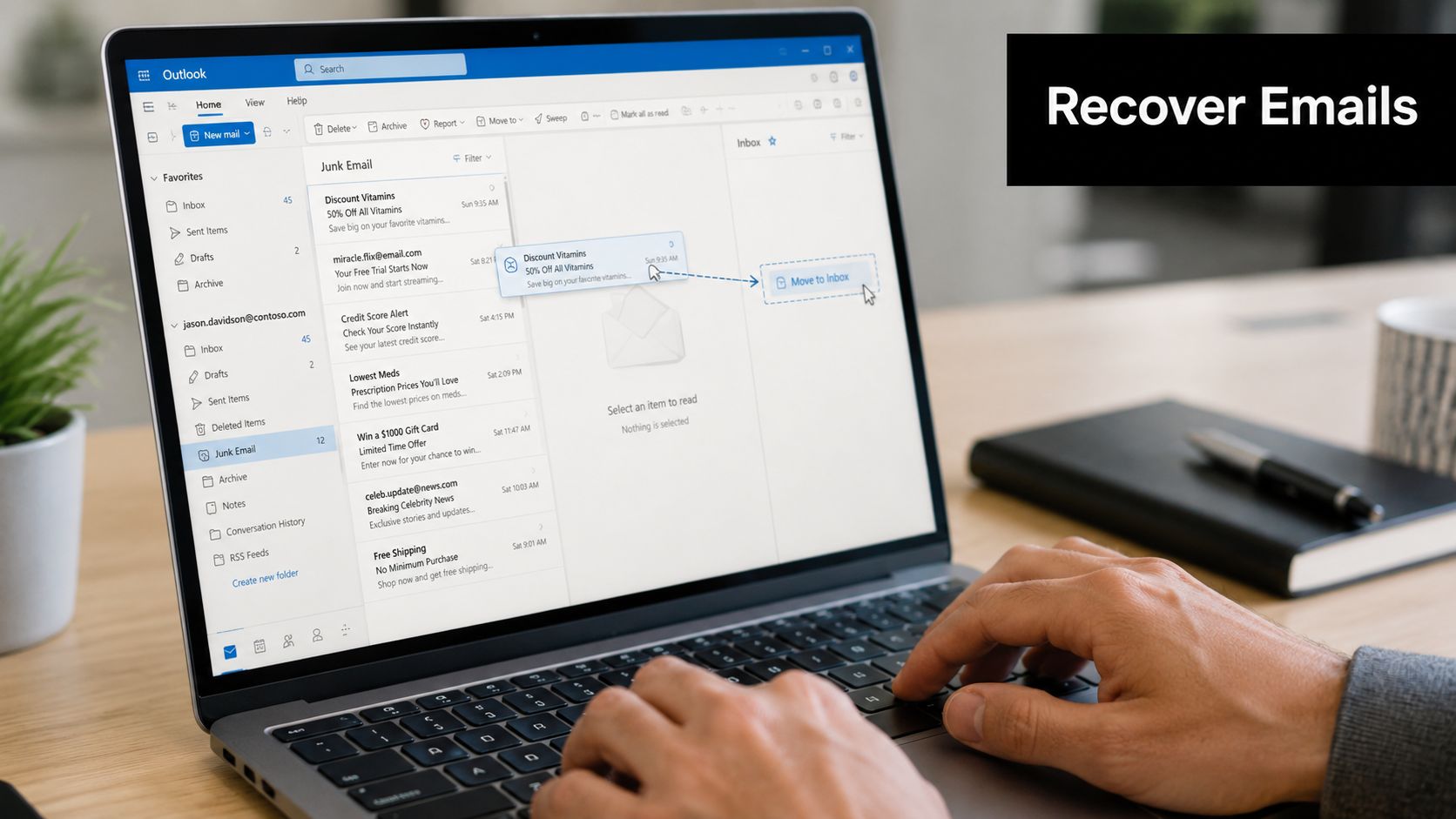 A person using a laptop to move an email from the junk folder in Microsoft Outlook.
